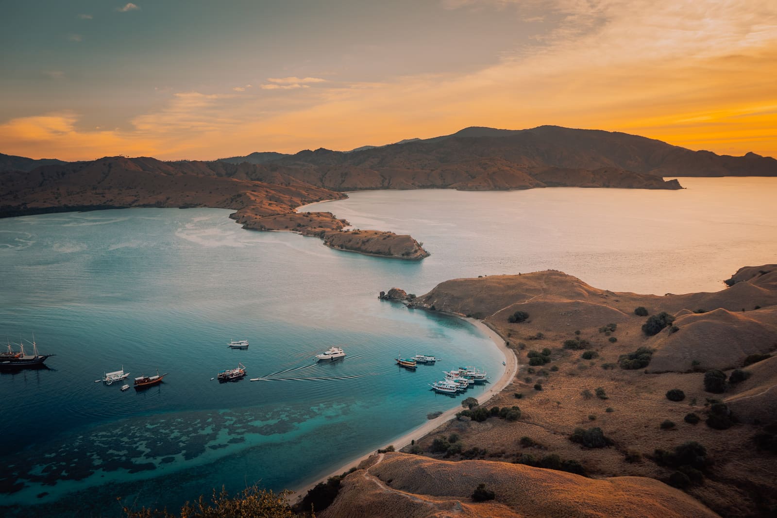 Sunset over the curved bays and hills of Gili Lawa