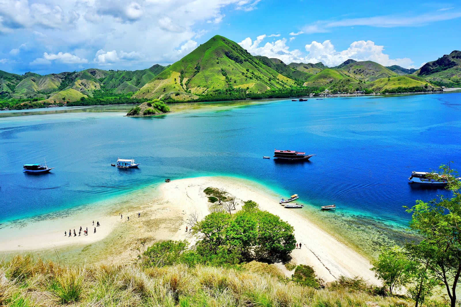 View from the top of Kelor Island over a white sandbar and boats