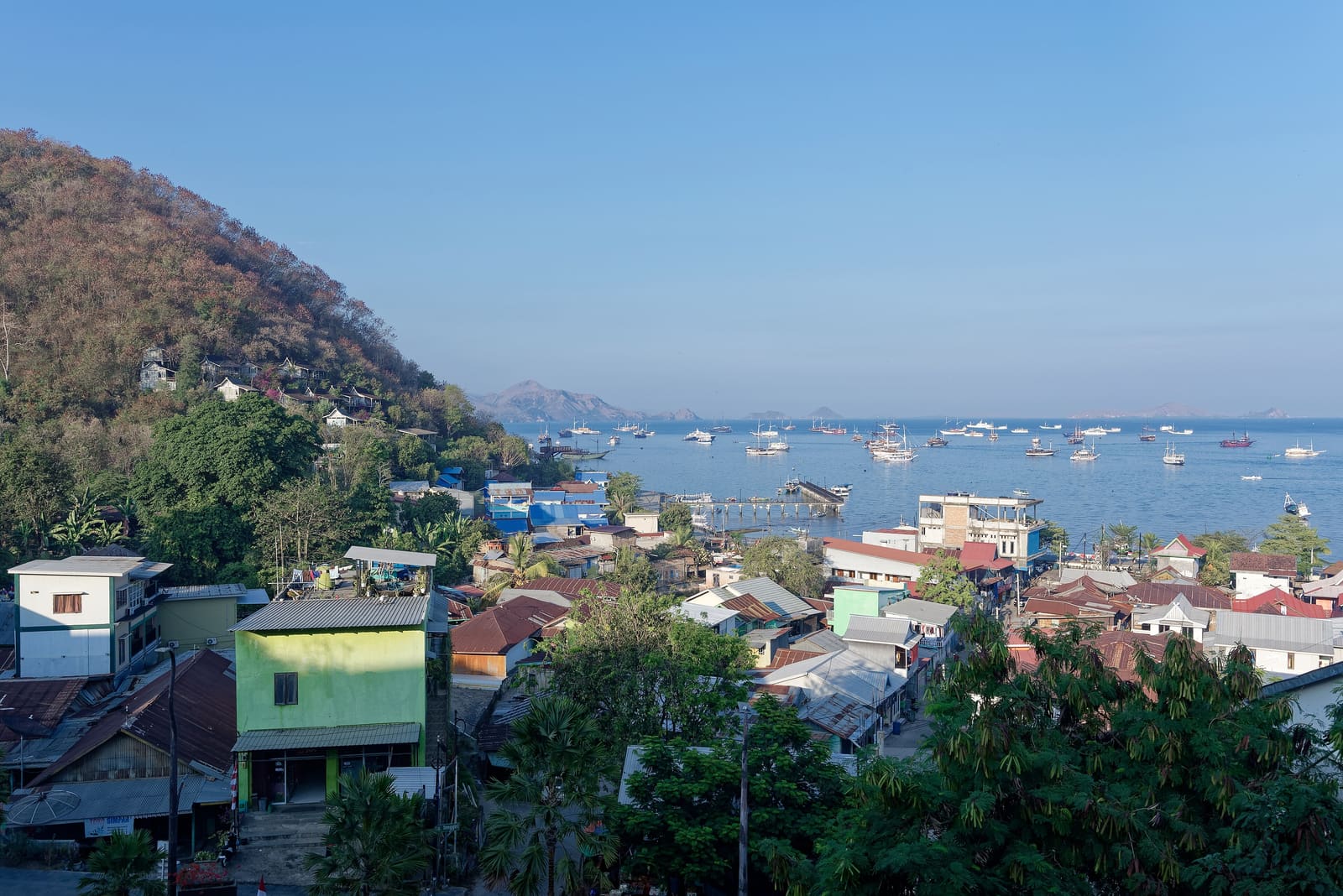 Labuan Bajo town and harbour full of boats on a sunny morning