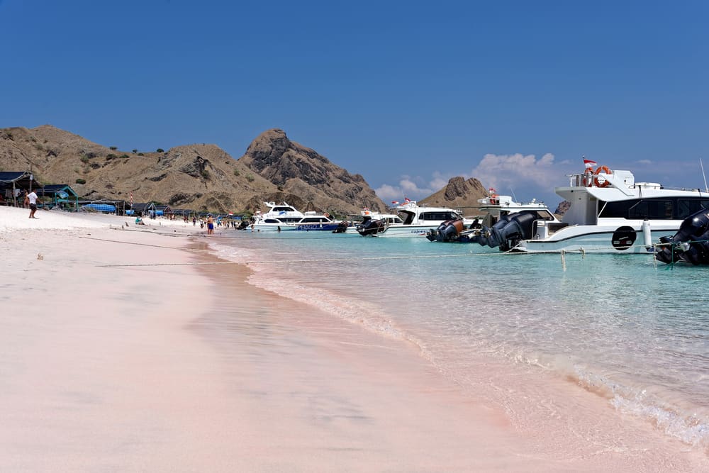 Speedboats moored at a turquoise sandbank in Komodo National Park